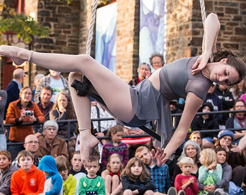 photo of Katie Schmidt, NECCA Coach, performing on dance trapeze