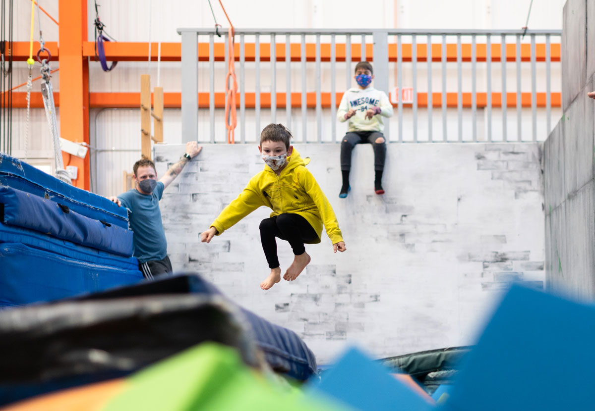 image of a youth student jumping on trampoline